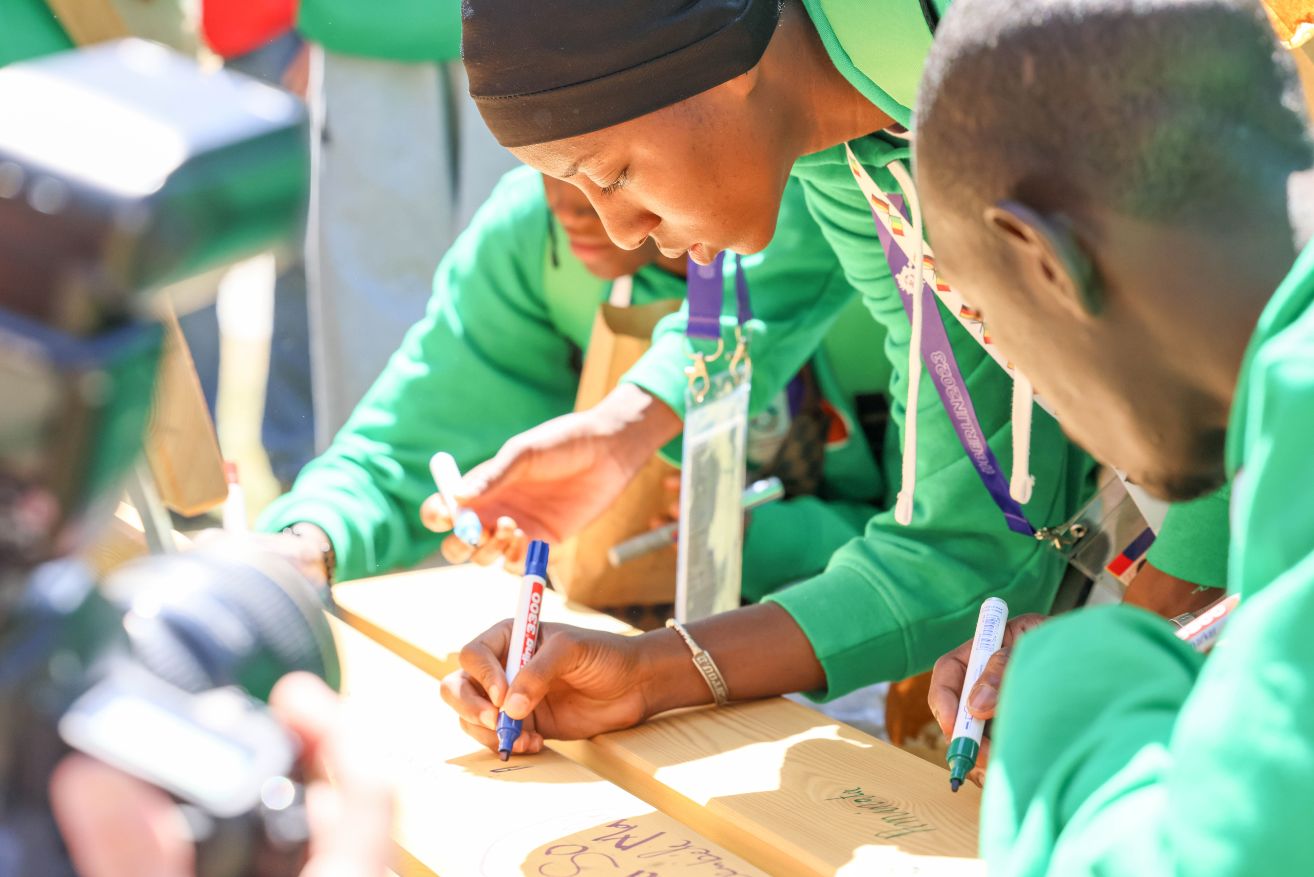 Person schreibt mit einem Stift auf Papier.
