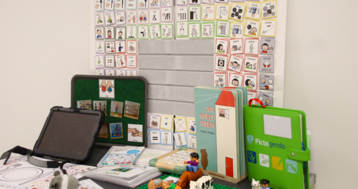 Spielzeug liegt auf einem Tisch. Es gibt Tiere und bunte Bausteine.